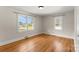 Bright bedroom with hardwood floors and two windows offering pleasant neighborhood views at 5170 Woodleaf Rd, Salisbury, NC 28147