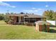 Exterior view of a cozy brick home with a screened-in porch, shed, and well-maintained lawn at 5170 Woodleaf Rd, Salisbury, NC 28147