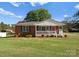 Charming brick home featuring a cozy front porch and well-manicured lawn, perfect for suburban living at 5170 Woodleaf Rd, Salisbury, NC 28147