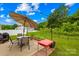 Backyard with a patio set, colorful plantings, and a view of the green lawn at 5204 Belstone Ln, Charlotte, NC 28215