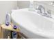 Close up on a white sink with chrome fixtures and shelf at 5204 Belstone Ln, Charlotte, NC 28215
