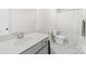 Bright bathroom featuring a single vanity, toilet, and shower/tub combination with tile flooring at 5204 Belstone Ln, Charlotte, NC 28215