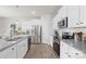 Bright kitchen featuring white cabinets, stainless steel appliances, and granite countertops at 5204 Belstone Ln, Charlotte, NC 28215