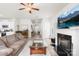An open living room connects to other rooms, featuring a cozy fireplace and television at 5204 Belstone Ln, Charlotte, NC 28215