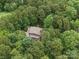 Aerial view of home nestled among lush trees, offering privacy and seclusion at 550 Burrage Ne Rd, Concord, NC 28025