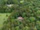 Aerial view of home nestled among lush trees on a large property at 550 Burrage Ne Rd, Concord, NC 28025