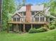 Spacious backyard view showcasing a large wooden deck with seating and a well-maintained lawn at 550 Burrage Ne Rd, Concord, NC 28025