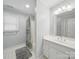 Bathroom with a single sink vanity, shower-tub combination with curtain, and patterned tile flooring at 550 Burrage Ne Rd, Concord, NC 28025