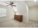 A cozy carpeted bedroom with a ceiling fan and window for natural light at 550 Burrage Ne Rd, Concord, NC 28025