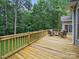 Large wooden deck with railing overlooking the backyard. Featuring outdoor seating and views of the surrounding trees at 550 Burrage Ne Rd, Concord, NC 28025