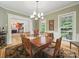 Elegant dining room featuring a chandelier, large table and scenic backyard view at 550 Burrage Ne Rd, Concord, NC 28025