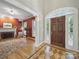 Elegant foyer with hardwood floors, a fireplace, and an eye-catching doorway at 550 Burrage Ne Rd, Concord, NC 28025