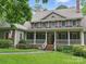 Charming two-story brick home featuring a welcoming front porch, manicured lawn, and a classic American aesthetic at 550 Burrage Ne Rd, Concord, NC 28025