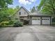 Spacious three-car garage with a paved driveway and well-maintained landscaping, adding convenience and curb appeal at 550 Burrage Ne Rd, Concord, NC 28025