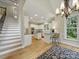 Open-concept kitchen with island, staircase and hardwood floors at 550 Burrage Ne Rd, Concord, NC 28025