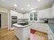 Beautiful kitchen with island cooktop and modern stainless steel appliances at 550 Burrage Ne Rd, Concord, NC 28025