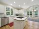 Bright kitchen with island cooktop, stainless steel appliances and hardwood floors at 550 Burrage Ne Rd, Concord, NC 28025
