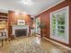 Cozy living room with a brick fireplace, built-in shelves, and natural light at 550 Burrage Ne Rd, Concord, NC 28025