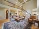 Spacious living room with high ceilings, grand staircase, and large decorative rug at 550 Burrage Ne Rd, Concord, NC 28025
