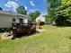 Expansive backyard with a wooden deck, creating a perfect setting for entertaining and outdoor activities at 6000 Amberly Ln, Charlotte, NC 28213