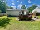 Private backyard with a wooden deck, great for outdoor gatherings and relaxation at 6000 Amberly Ln, Charlotte, NC 28213