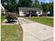 Charming single-story home with a well-maintained lawn and a paved driveway at 6000 Amberly Ln, Charlotte, NC 28213