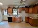 Functional kitchen with wood cabinets and a view to the outside, ideal for meal prep and casual dining at 6000 Amberly Ln, Charlotte, NC 28213