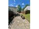 Stone patio area ideal for BBQs and outdoor enjoyment, complemented by the lush greenery of the yard at 6000 Amberly Ln, Charlotte, NC 28213
