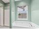 This bathroom has a soaking tub and window with a view of the outdoors at 6309 Margaret Ct, Indian Trail, NC 28079