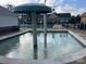 Community pool with a splash pad and seating, perfect for relaxation and outdoor activities at 6309 Margaret Ct, Indian Trail, NC 28079