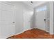 Bright entryway with hardwood floors, white doors, and a large window providing natural light at 6309 Margaret Ct, Indian Trail, NC 28079