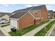 Brick townhouse includes garage, driveway, and lawn at 6309 Margaret Ct, Indian Trail, NC 28079