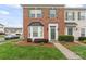 Beautiful brick townhome featuring a well-maintained lawn, bay window and green shutters at 6309 Margaret Ct, Indian Trail, NC 28079
