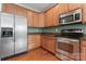 Kitchen featuring stainless steel appliances, granite countertops, and wooden cabinets at 6309 Margaret Ct, Indian Trail, NC 28079