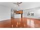 Open-concept living room featuring hardwood floors, great natural light, and a view into the kitchen at 6309 Margaret Ct, Indian Trail, NC 28079
