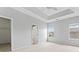 Spacious primary bedroom with tray ceiling, two windows, and neutral tones at 6309 Margaret Ct, Indian Trail, NC 28079