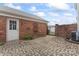 Private brick patio features brick privacy wall, gate, and door to the home at 6309 Margaret Ct, Indian Trail, NC 28079
