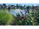 Scenic view of a tranquil pond with a fountain, lush greenery, and beautiful landscaping at 6309 Margaret Ct, Indian Trail, NC 28079