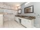 Bright bathroom featuring a double vanity with granite countertops, tile flooring, and a tiled backsplash at 6419 Antioch Ct, Matthews, NC 28104