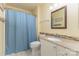 Bathroom featuring a single vanity with granite countertop, a white cabinet, and a blue shower curtain at 6419 Antioch Ct, Matthews, NC 28104