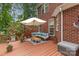 Inviting outdoor deck with comfortable seating, an umbrella and potted plants perfect for outdoor entertaining and relaxation at 6419 Antioch Ct, Matthews, NC 28104