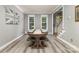 Bright dining area with large wooden table, benches, and plenty of natural light from the surrounding windows at 6419 Antioch Ct, Matthews, NC 28104