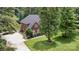 Charming brick home featuring a well-kept lawn, mature trees, and a paved driveway, showcasing curb appeal at 6419 Antioch Ct, Matthews, NC 28104