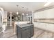 Modern kitchen with a center island and granite countertops overlooks the adjoining dining and living rooms at 6419 Antioch Ct, Matthews, NC 28104