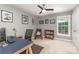 Cozy home office with a ceiling fan, large window, and comfortable seating for a productive and inviting workspace at 6419 Antioch Ct, Matthews, NC 28104