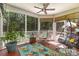 Charming screened-in porch with hanging chairs, ceiling fan, and leafy green views offering a relaxing space at 6419 Antioch Ct, Matthews, NC 28104