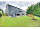 A sprawling backyard with a patio, outdoor seating, playset, and well-maintained lawn at 645 Brookhaven Dr, Fort Mill, SC 29708