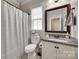 Cozy bathroom featuring granite countertops, a decorative mirror, and a shower with a curtain at 645 Brookhaven Dr, Fort Mill, SC 29708