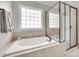 Bathroom showcasing a luxurious tub, glass-enclosed shower, and tile flooring at 645 Brookhaven Dr, Fort Mill, SC 29708