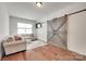 Cozy upstairs bonus room with a sofa, hardwood floors, natural light, and a barn door with dark trim at 645 Brookhaven Dr, Fort Mill, SC 29708